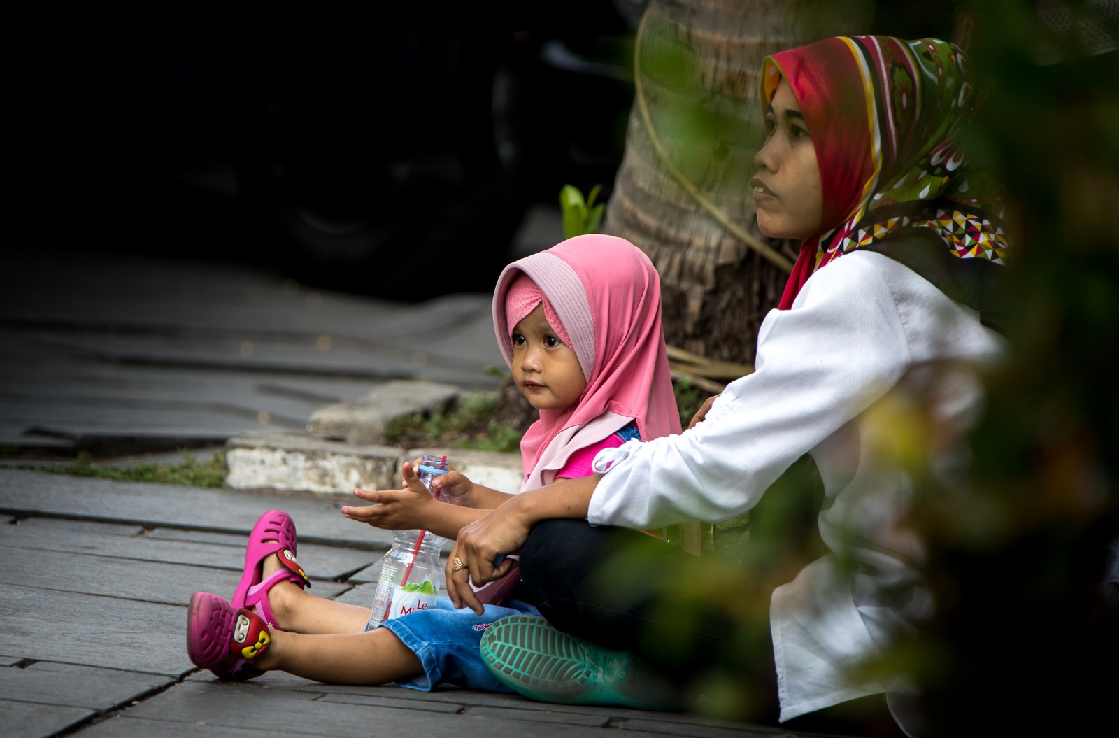 Fotka se zdá smutná. Holčička s maminkou ale jen klidně sedí na ulici, za chvíli je vyzvedl tatínek a odjeli docela slušným autem - Ladislav Hanousek, Indonésie